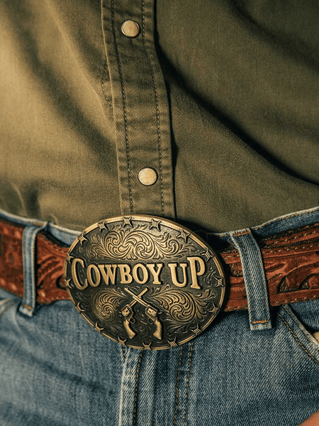 Montana Silversmiths A1007C Cowboy Up Attitude Buckle Brass on model. If you need any assistance with this item or the purchase of this item please call us at five six one seven four eight eight eight zero one Monday through Saturday 10:00a.m EST to 8:00 p.m EST