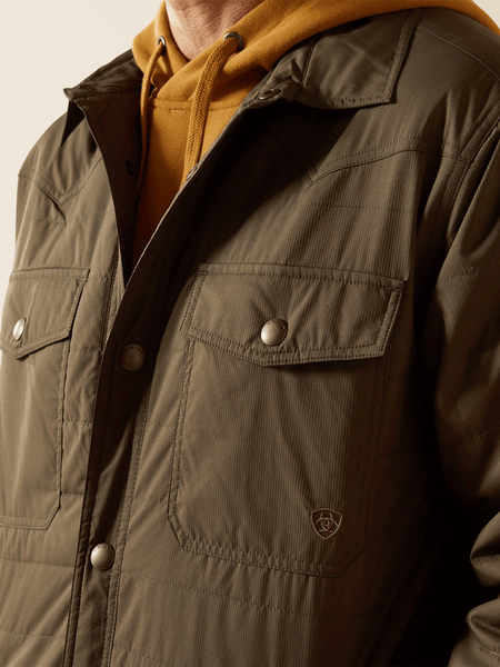 Ariat 10062512 Mens Quilted Shirt Jacket Dark Olive Green front close up view. If you need any assistance with this item or the purchase of this item please call us at five six one seven four eight eight eight zero one Monday through Saturday 10:00a.m EST to 8:00 p.m EST