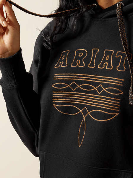 Ariat 10062734 Womens Booted Logo Hoodie Black close up. If you need any assistance with this item or the purchase of this item please call us at five six one seven four eight eight eight zero one Monday through Saturday 10:00a.m EST to 8:00 p.m EST