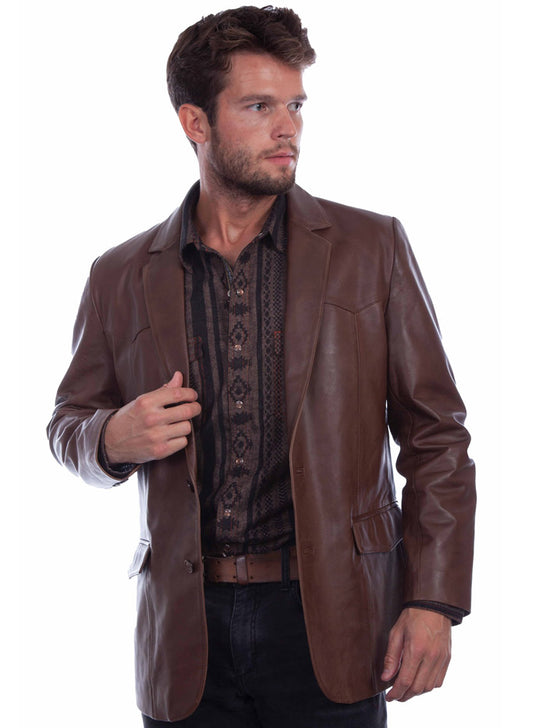 A man wearing a brown leather blazer over a dark patterned shirt and jeans, photographed against a plain white background. If you need any assistance with this item or the purchase of this item please call us at five six one seven four eight eight eight zero one Monday through Saturday 10:00a.m EST to 8:00 p.m EST