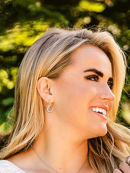 Montana Silversmiths ER5700 Womens Heartfelt Luck Horseshoe Earrings Silver on model. If you need any assistance with this item or the purchase of this item please call us at five six one seven four eight eight eight zero one Monday through Saturday 10:00a.m EST to 8:00 p.m EST