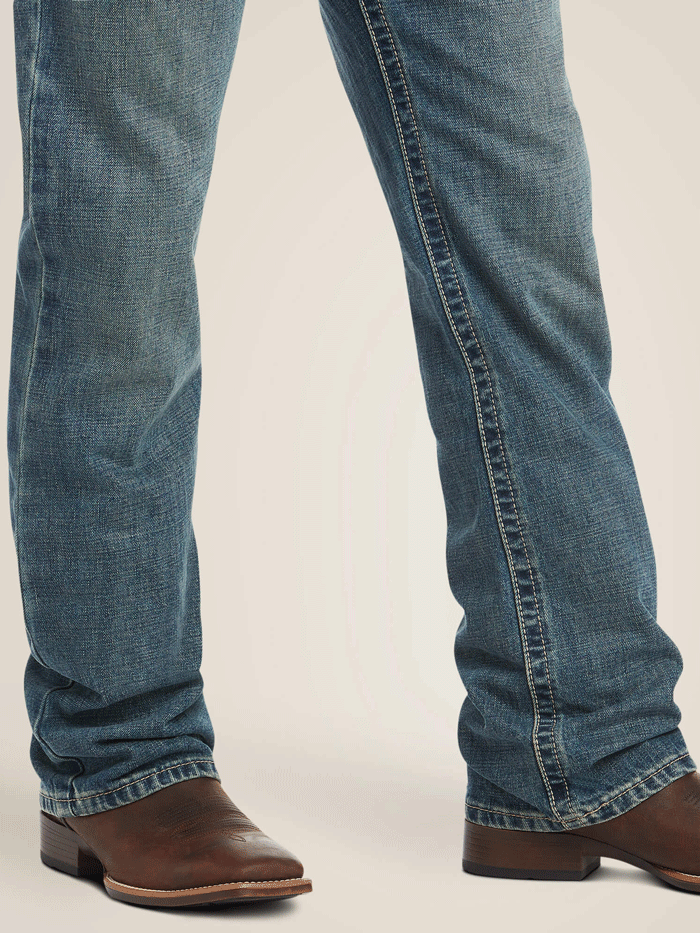 Ariat 10012136 Mens M4 Low Rise Boundary Boot Cut Jean Gulch Denim front view. If you need any assistance with this item or the purchase of this item please call us at five six one seven four eight eight eight zero one Monday through Saturday 10:00a.m EST to 8:00 p.m EST