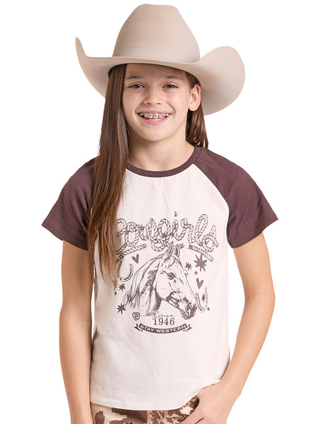 A smiling girl wearing a beige cowboy hat and a raglan-style t-shirt with a brown graphic of a horse and the words Cowgirl. If you need any assistance with this item or the purchase of this item please call us at five six one seven four eight eight eight zero one Monday through Saturday 10:00a.m EST to 8:00 p.m EST