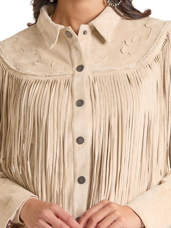 A close-up of a beige suede western-style fringed blouse with a pointed collar, decorative embroidery on the yoke, and dark buttons, shown on a model. If you need any assistance with this item or the purchase of this item please call us at five six one seven four eight eight eight zero one Monday through Saturday 10:00a.m EST to 8:00 p.m EST