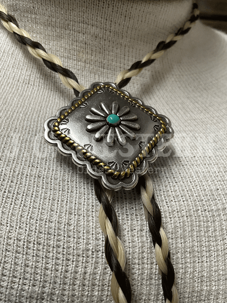 Cowboy Collectibles BOLT514 Golden Lasso Turquoise Square Bolo Tie Creme And Dark Sorrel close up. If you need any assistance with this item or the purchase of this item please call us at five six one seven four eight eight eight zero one Monday through Saturday 10:00a.m EST to 8:00 p.m EST