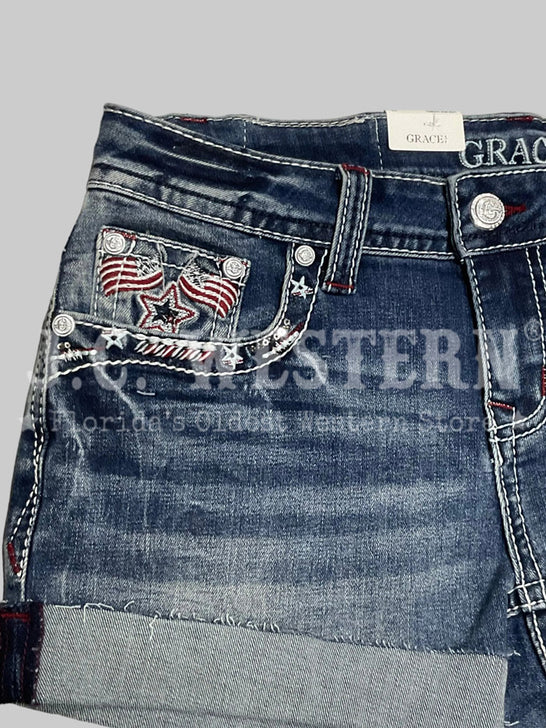 Grace in LA JHW62055 Womens America Flap Low Rise Shorts Denim front close up. If you need any assistance with this item or the purchase of this item please call us at five six one seven four eight eight eight zero one Monday through Saturday 10:00a.m EST to 8:00 p.m EST