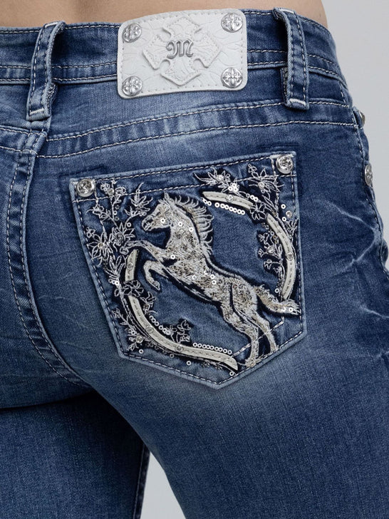 Miss Me M9627BL Womens Mid Rise Bootcut Jeans Medium Blue close up. If you need any assistance with this item or the purchase of this item please call us at five six one seven four eight eight eight zero one Monday through Saturday 10:00a.m EST to 8:00 p.m EST