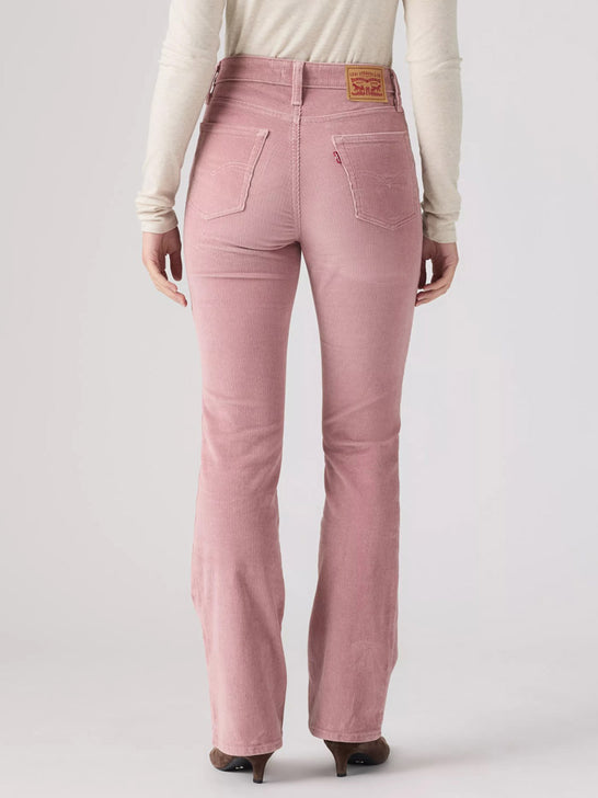 A person shown from the back wearing pink corduroy jeans with a cream long-sleeve top and dark brown heels, photographed against a light gray studio background. If you need any assistance with this item or the purchase of this item please call us at five six one seven four eight eight eight zero one Monday through Saturday 10:00a.m EST to 8:00 p.m EST