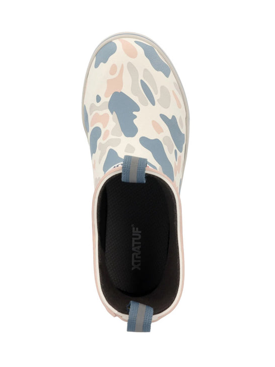 A single slip-on water shoe shown from a top-down view on a white background. The shoe features a light beige upper with a blue and pink camouflage pattern, a black interior, and a light blue pull tab. If you need any assistance with this item or the purchase of this item please call us at five six one seven four eight eight eight zero one Monday through Saturday 10:00a.m EST to 8:00 p.m EST