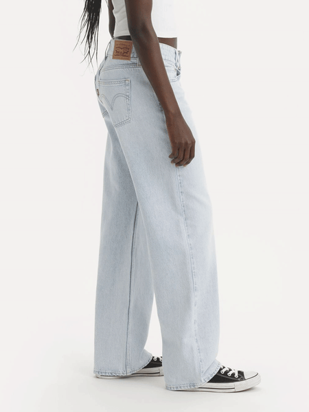 Levi's A74980007 Womens Superlow Loose Jeans Abraided Art Light Blue side view.If you need any assistance with this item or the purchase of this item please call us at five six one seven four eight eight eight zero one Monday through Saturday 10:00a.m EST to 8:00 p.m EST