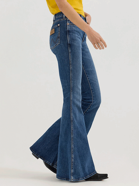 Wrangler 112360638 Womens X Lainey Wilson Bell Bottoms Jeans Baskin Blue Wash side. If you need any assistance with this item or the purchase of this item please call us at five six one seven four eight eight eight zero one Monday through Saturday 10:00a.m EST to 8:00 p.m EST