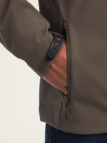 Ariat 10041614 Mens Logo 2.0 Softshell Jacket Banyan Bark side pocket close up view. If you need any assistance with this item or the purchase of this item please call us at five six one seven four eight eight eight zero one Monday through Saturday 10:00a.m EST to 8:00 p.m EST