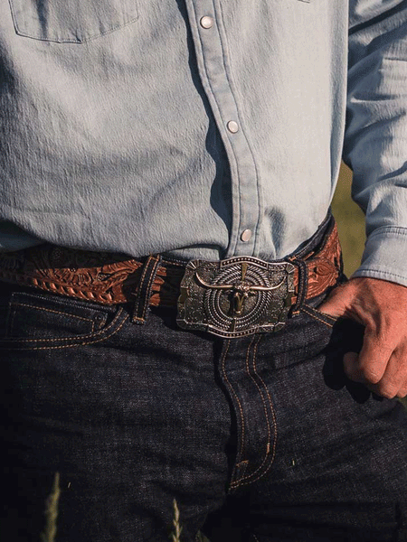 Montana Silversmiths A930 Ropin’ Ready Longhorn Attitude Buckle Silver on male model. If you need any assistance with this item or the purchase of this item please call us at five six one seven four eight eight eight zero one Monday through Saturday 10:00a.m EST to 8:00 p.m EST