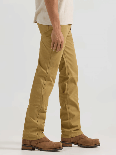 Wrangler 112361473 Mens Premium Performance Tough Comfort Cowboy Cut Slim Fit Canvas Jean Kelp side view. If you need any assistance with this item or the purchase of this item please call us at five six one seven four eight eight eight zero one Monday through Saturday 10:00a.m EST to 8:00 p.m EST