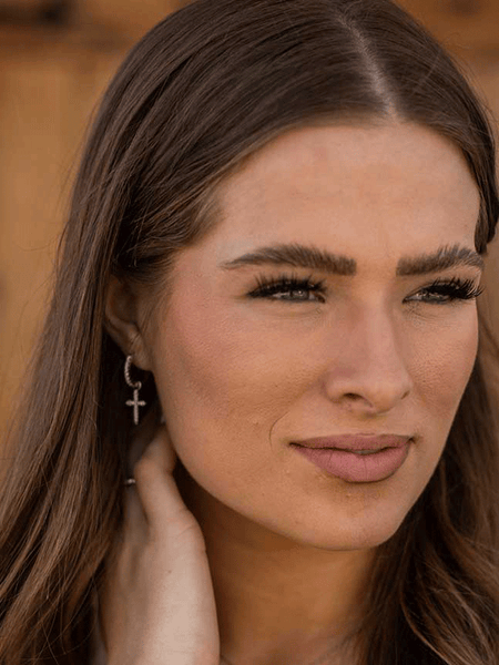 Montana Silversmiths ER5642 Womens Crystal Devotion Cross Earrings Silver on model. If you need any assistance with this item or the purchase of this item please call us at five six one seven four eight eight eight zero one Monday through Saturday 10:00a.m EST to 8:00 p.m EST