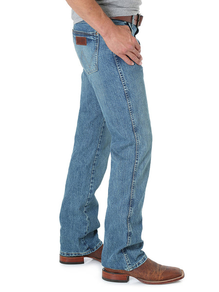 Wrangler 77MWZWO Mens Retro Jeans Slim Boot Worn side view. If you need any assistance with this item or the purchase of this item please call us at five six one seven four eight eight eight zero one Monday through Saturday 10:00a.m EST to 8:00 p.m EST