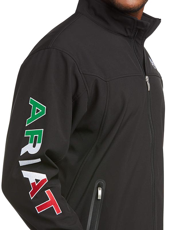 Ariat 10031424 Mens New Team Softshell Mexico Wtr Rstnt Jkt Black front view. If you need any assistance with this item or the purchase of this item please call us at five six one seven four eight eight eight zero one Monday through Saturday 10:00a.m EST to 8:00 p.m EST