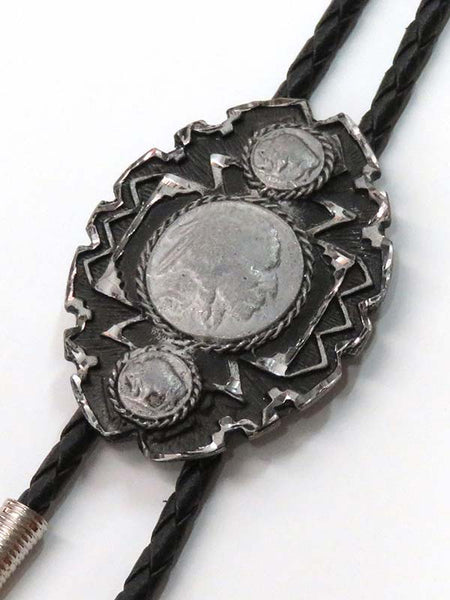 Western Express BT-132 Native American Head Coin Bolo Tie Grey close up. If you need any assistance with this item or the purchase of this item please call us at five six one seven four eight eight eight zero one Monday through Saturday 10:00a.m EST to 8:00 p.m EST