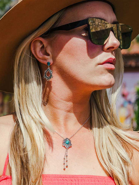 Montana Silversmiths NC4951 Womens Lady Guadalupe Dangle Stone Necklace Turquoise on model. If you need any assistance with this item or the purchase of this item please call us at five six one seven four eight eight eight zero one Monday through Saturday 10:00a.m EST to 8:00 p.m EST