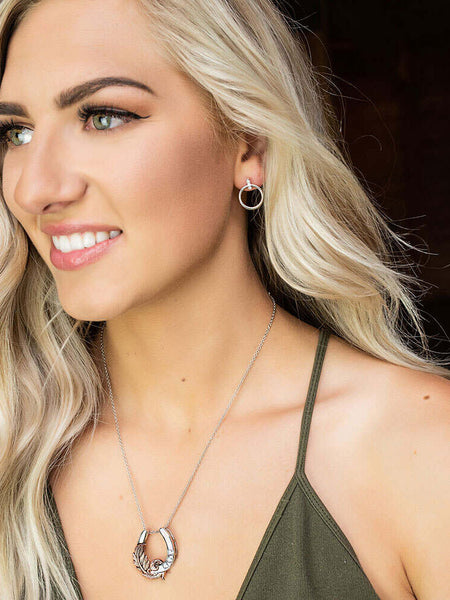 Montana Silversmiths NC4621 Natural Luck Horseshoe Necklace with a girl. If you need any assistance with this item or the purchase of this item please call us at five six one seven four eight eight eight zero one Monday through Saturday 10:00a.m EST to 8:00 p.m EST