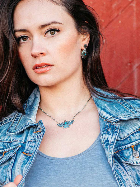 Montana Silversmiths NC4905 Rising Above Thunderbird Turquoise Necklace WITH A GIRL. If you need any assistance with this item or the purchase of this item please call us at five six one seven four eight eight eight zero one Monday through Saturday 10:00a.m EST to 8:00 p.m EST