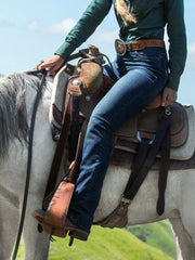 Wrangler WRW60LE Womens Willow Lovette Ultimate Riding Jean riding a horse. If you need any assistance with this item or the purchase of this item please call us at five six one seven four eight eight eight zero one Monday through Saturday 10:00a.m EST to 8:00 p.m EST
