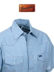 Wrangler 70131MW Mens Western Short Sleeve Chambray Work Shirt Light Blue front close up. If you need any assistance with this item or the purchase of this item please call us at five six one seven four eight eight eight zero one Monday through Saturday 10:00a.m EST to 8:00 p.m EST