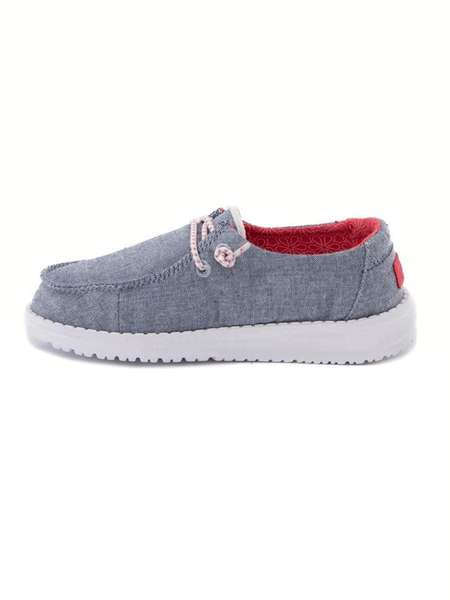 Hey Dude 130125704 Wendy Youth Shoe Chambray Braid side view. If you need any assistance with this item or the purchase of this item please call us at five six one seven four eight eight eight zero one Monday through Saturday 10:00a.m EST to 8:00 p.m EST