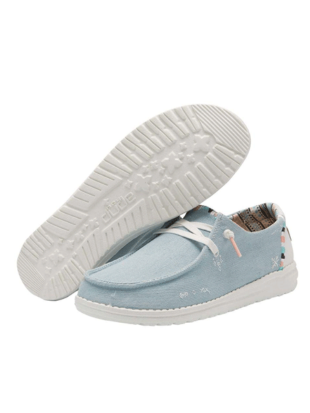 Hey Dude 121412412 Womens Wendy Boho Shoe Light Denim front and sole view. If you need any assistance with this item or the purchase of this item please call us at five six one seven four eight eight eight zero one Monday through Saturday 10:00a.m EST to 8:00 p.m EST