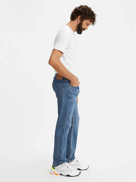 Levi’s 005052217 Mens 505 Regular Fit Stretch Jeans Fremont Drop Shot - Medium Wash side view. If you need any assistance with this item or the purchase of this item please call us at five six one seven four eight eight eight zero one Monday through Saturday 10:00a.m EST to 8:00 p.m EST