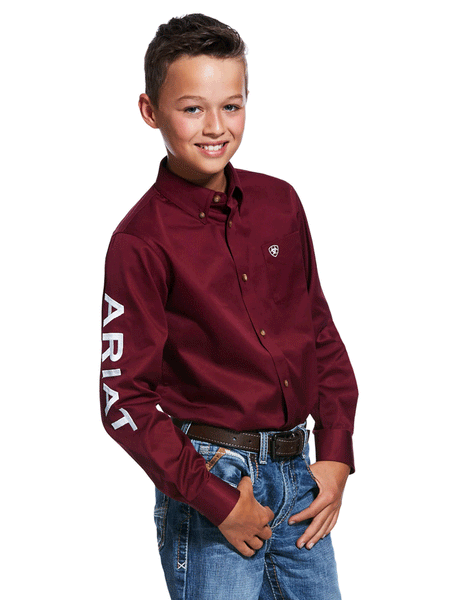 Ariat 10030163 Kids Team Logo Twill Classic Fit Shirt Burgundy front and side view. If you need any assistance with this item or the purchase of this item please call us at five six one seven four eight eight eight zero one Monday through Saturday 10:00a.m EST to 8:00 p.m EST