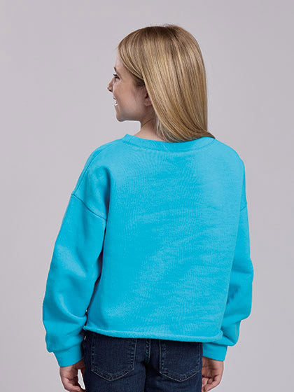 A young girl with blonde hair smiling while wearing a bright turquoise blue sweatshirt with a red graphic of two dancing figures, paired with dark blue jeans, against a solid gray studio background. If you need any assistance with this item or the purchase of this item please call us at five six one seven four eight eight eight zero one Monday through Saturday 10:00a.m EST to 8:00 p.m EST