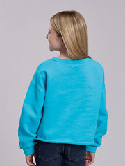 A woman with blonde hair is shown from the back wearing a bright turquoise blue cropped crewneck sweatshirt and dark blue jeans, set against a solid light gray studio background. If you need any assistance with this item or the purchase of this item please call us at five six one seven four eight eight eight zero one Monday through Saturday 10:00a.m EST to 8:00 p.m EST