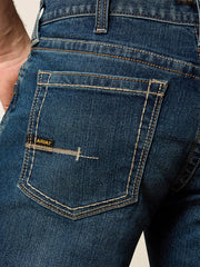 Ariat 10016220 Mens Rebar M4 Relaxed DuraStretch Edge Boot Cut Jean Bodie Navy back pocket close up. If you need any assistance with this item or the purchase of this item please call us at five six one seven four eight eight eight zero one Monday through Saturday 10:00a.m EST to 8:00 p.m EST