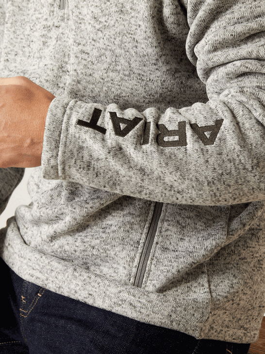 Ariat 10046490 Mens Caldwell Logo Zip Sweater Nulla Heather sleeve view. If you need any assistance with this item or the purchase of this item please call us at five six one seven four eight eight eight zero one Monday through Saturday 10:00a.m EST to 8:00 p.m EST