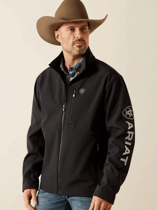 Ariat 10062578 Mens Logo Softshell Jacket Black front view. If you need any assistance with this item or the purchase of this item please call us at five six one seven four eight eight eight zero one Monday through Saturday 10:00a.m EST to 8:00 p.m EST