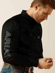Ariat 10062659 Mens Team Logo Twill Fitted Shirt Black sleeve close up. If you need any assistance with this item or the purchase of this item please call us at five six one seven four eight eight eight zero one Monday through Saturday 10:00a.m EST to 8:00 p.m EST