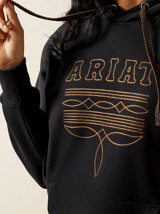Ariat 10062734 Womens Booted Logo Hoodie Black close up. If you need any assistance with this item or the purchase of this item please call us at five six one seven four eight eight eight zero one Monday through Saturday 10:00a.m EST to 8:00 p.m EST