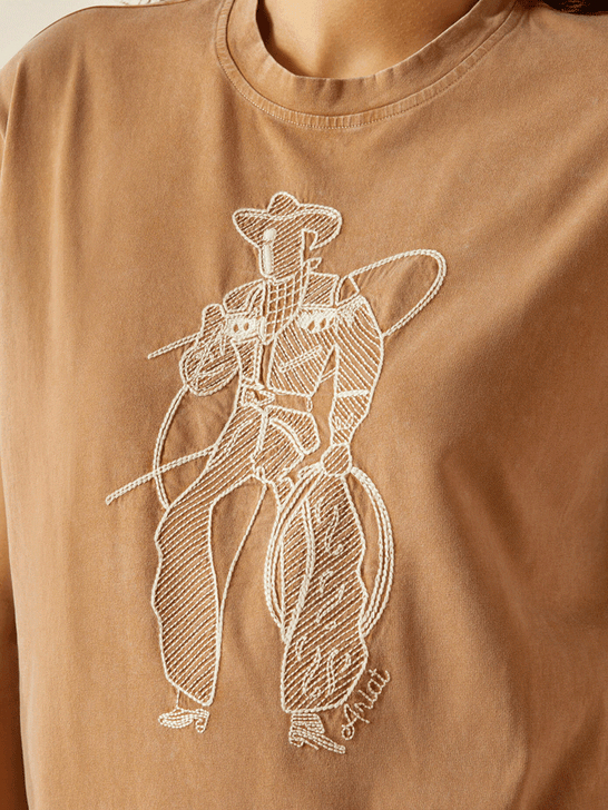 Ariat 10062917 Womens Buckaroo T-Shirt Toasted Coconut Tan front close up. If you need any assistance with this item or the purchase of this item please call us at five six one seven four eight eight eight zero one Monday through Saturday 10:00a.m EST to 8:00 p.m EST
