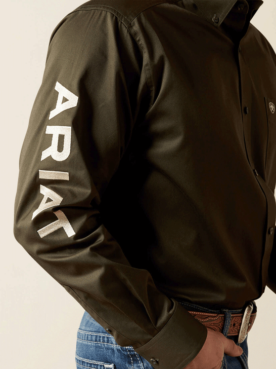 Ariat 10065845 Mens Team Logo Twill Classic Fit Shirt Olive sleeve view. If you need any assistance with this item or the purchase of this item please call us at five six one seven four eight eight eight zero one Monday through Saturday 10:00a.m EST to 8:00 p.m EST
