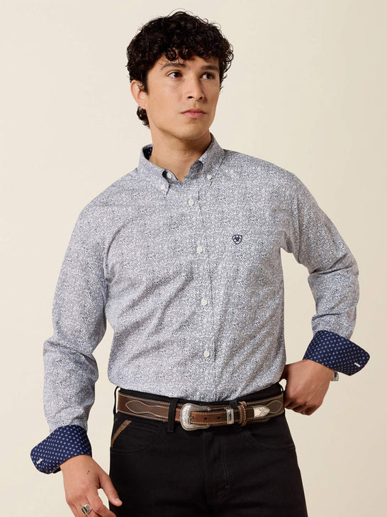 A man wearing a light gray and white micro-patterned button-down shirt with dark blue patterned cuffs, paired with black pants and a brown belt, against a solid beige background. If you need any assistance with this item or the purchase of this item please call us at five six one seven four eight eight eight zero one Monday through Saturday 10:00a.m EST to 8:00 p.m EST