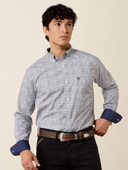 A man wearing a light gray and white micro-patterned button-down shirt with dark blue patterned cuffs, paired with black pants and a brown belt, against a solid beige background. If you need any assistance with this item or the purchase of this item please call us at five six one seven four eight eight eight zero one Monday through Saturday 10:00a.m EST to 8:00 p.m EST