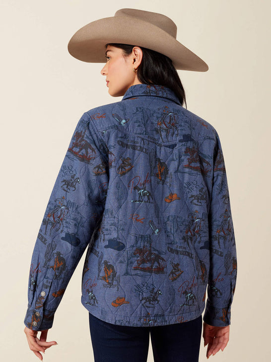 A woman shown from the back wearing a blue western-style quilted shirt jacket with a cowboy hat, set against a plain beige studio background. If you need any assistance with this item or the purchase of this item please call us at five six one seven four eight eight eight zero one Monday through Saturday 10:00a.m EST to 8:00 p.m EST