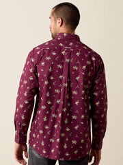 A man viewed from the back wearing a long-sleeve button-up shirt in deep burgundy with a repeating beige graphic print, paired with dark gray jeans against a plain beige studio background. If you need any assistance with this item or the purchase of this item please call us at five six one seven four eight eight eight zero one Monday through Saturday 10:00a.m EST to 8:00 p.m EST