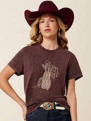 Ariat 10079672 Womens Rebel With A Cause T-Shirt Dark Brown front view.If you need any assistance with this item or the purchase of this item please call us at five six one seven four eight eight eight zero one Monday through Saturday 10:00a.m EST to 8:00 p.m EST
