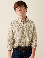 A young boy with red hair and freckles wearing a long-sleeve button-down shirt with a beige and brown cactus pattern, paired with dark blue jeans and a brown belt, against a solid light beige background. If you need any assistance with this item or the purchase of this item please call us at five six one seven four eight eight eight zero one Monday through Saturday 10:00a.m EST to 8:00 p.m EST
