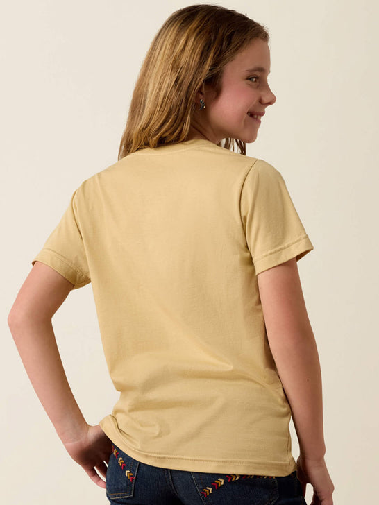 A young girl with blonde hair is shown from the back wearing a pale yellow short-sleeve t-shirt and dark blue jeans with colorful embroidery on the back pockets, set against a plain off-white background. If you need any assistance with this item or the purchase of this item please call us at five six one seven four eight eight eight zero one Monday through Saturday 10:00a.m EST to 8:00 p.m EST