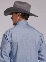 A man shown from the back wearing a gray cowboy hat and a light blue textured western shirt against a plain light gray studio background. If you need any assistance with this item or the purchase of this item please call us at five six one seven four eight eight eight zero one Monday through Saturday 10:00a.m EST to 8:00 p.m EST