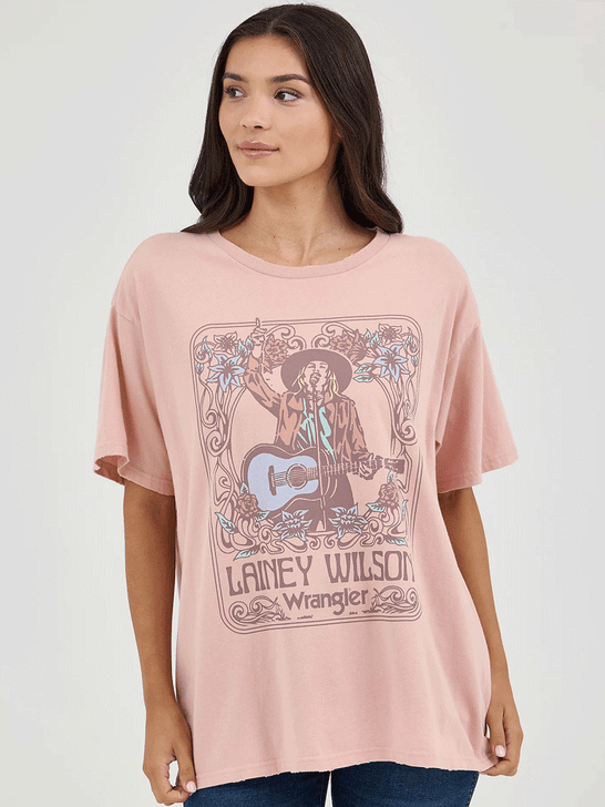 Wrangler 112361044 Womens Lainey Wilson Oversized Band Tee Misty Rose front view. If you need any assistance with this item or the purchase of this item please call us at five six one seven four eight eight eight zero one Monday through Saturday 10:00a.m EST to 8:00 p.m EST
