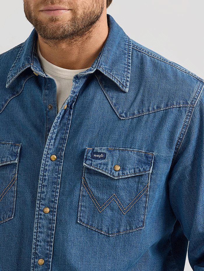 Wrangler 112361701 Mens Classic Denim Western Snap Shirt Mid Wash Denim front view. If you need any assistance with this item or the purchase of this item please call us at five six one seven four eight eight eight zero one Monday through Saturday 10:00a.m EST to 8:00 p.m EST